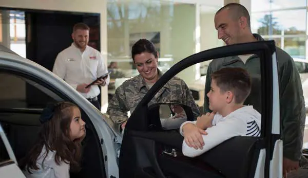 MAS employee showing a car to customers